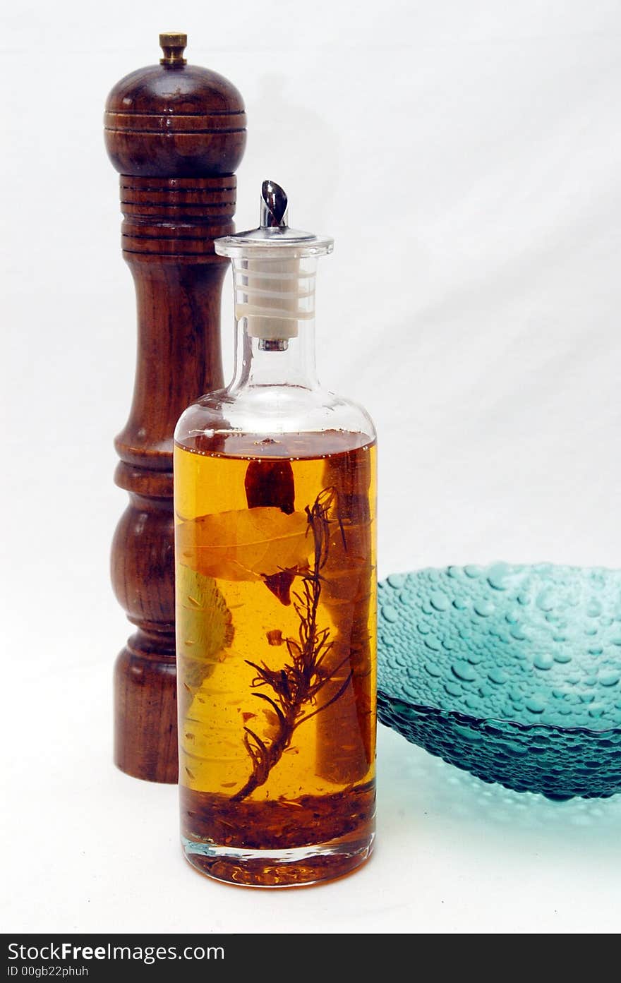 Oil bottle and pepper mill in a white background. Oil bottle and pepper mill in a white background