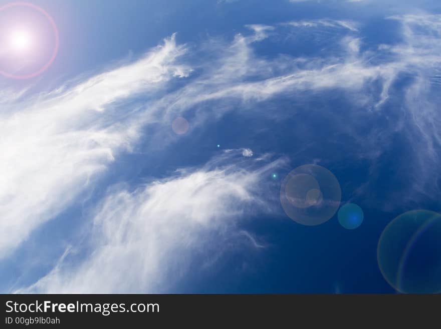 Blue sky and clouds texture with lens flare. Blue sky and clouds texture with lens flare