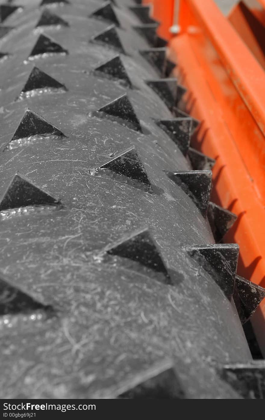 Large metal teeth on the roller of an agricultural machine. Large metal teeth on the roller of an agricultural machine