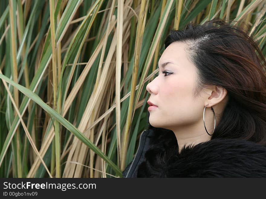 Asian girl looking up with both hands up too