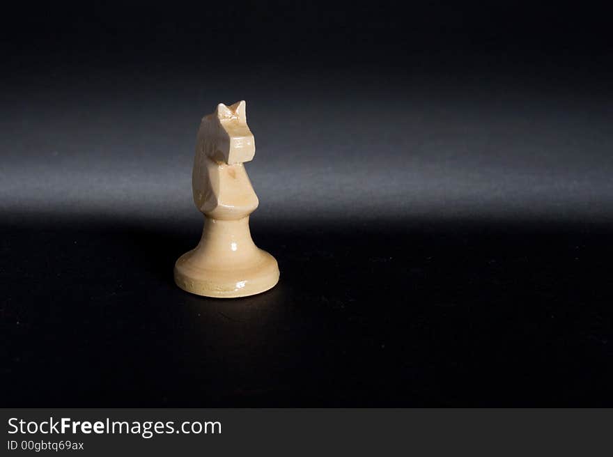 Isolated hand made wood chess horse piece. Isolated hand made wood chess horse piece