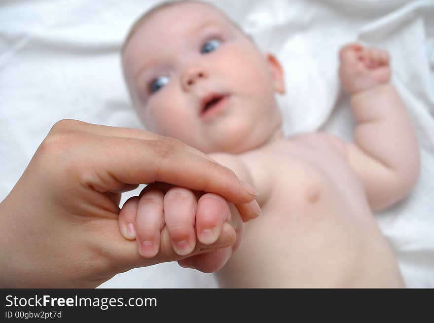 Mother massaging hands of her baby. Mother massaging hands of her baby