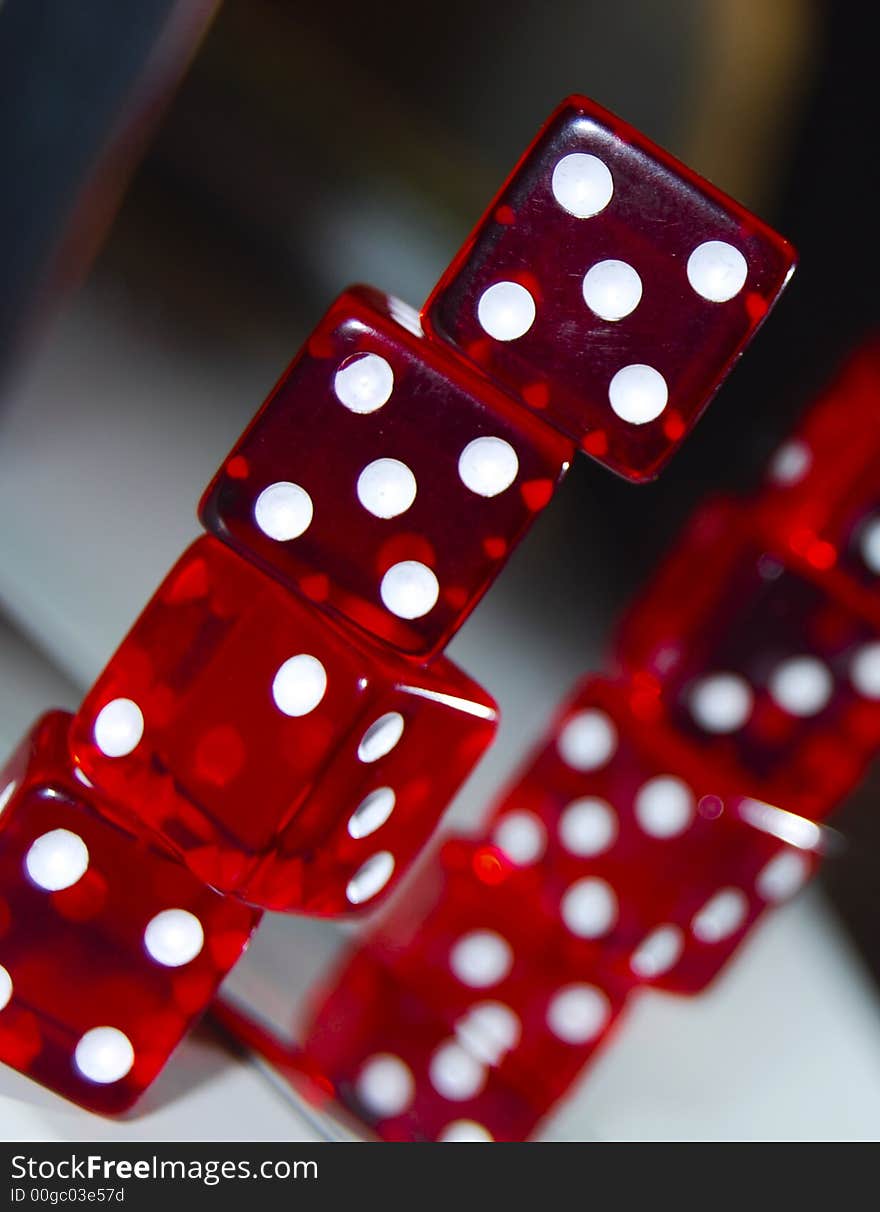 Red dice close ups infront of a mirror on top of each other