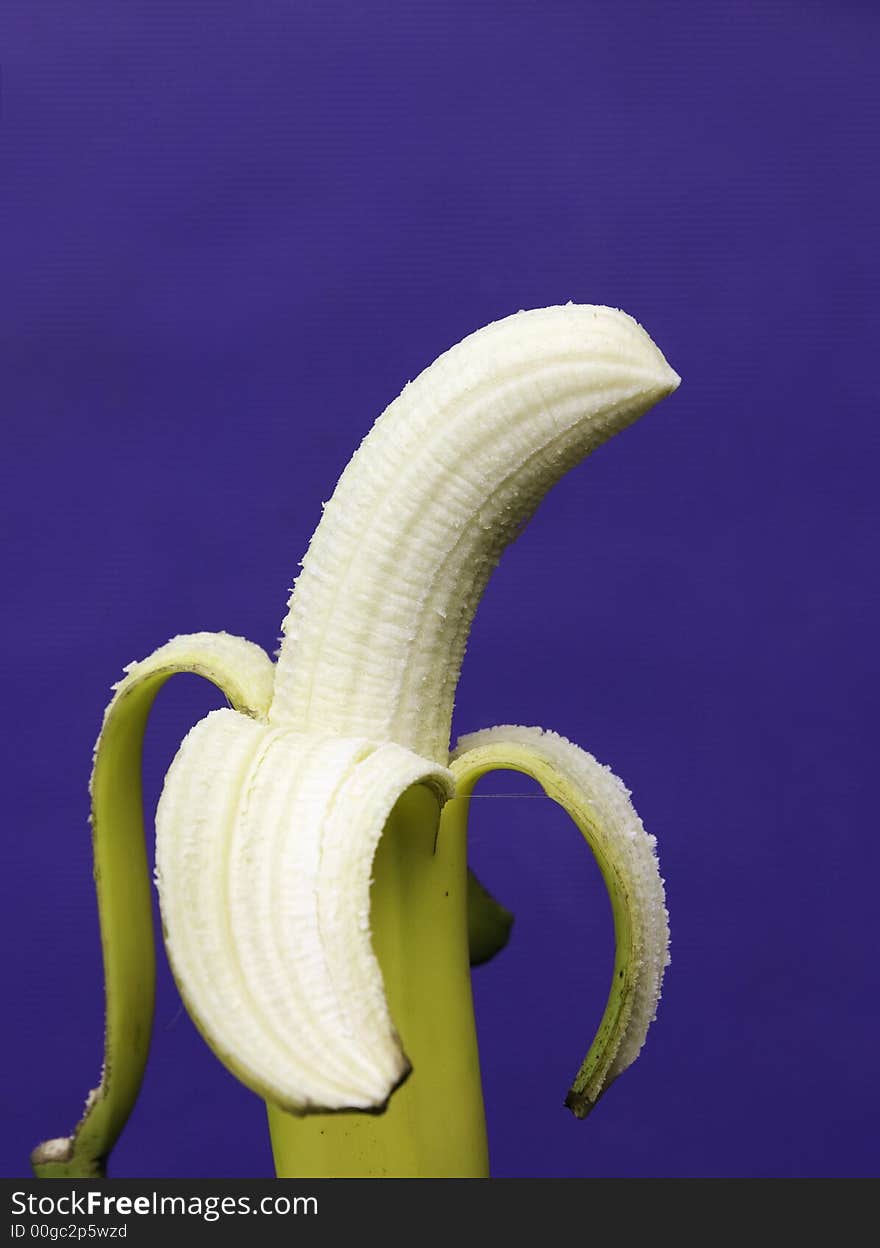 Peeled banana with blue background