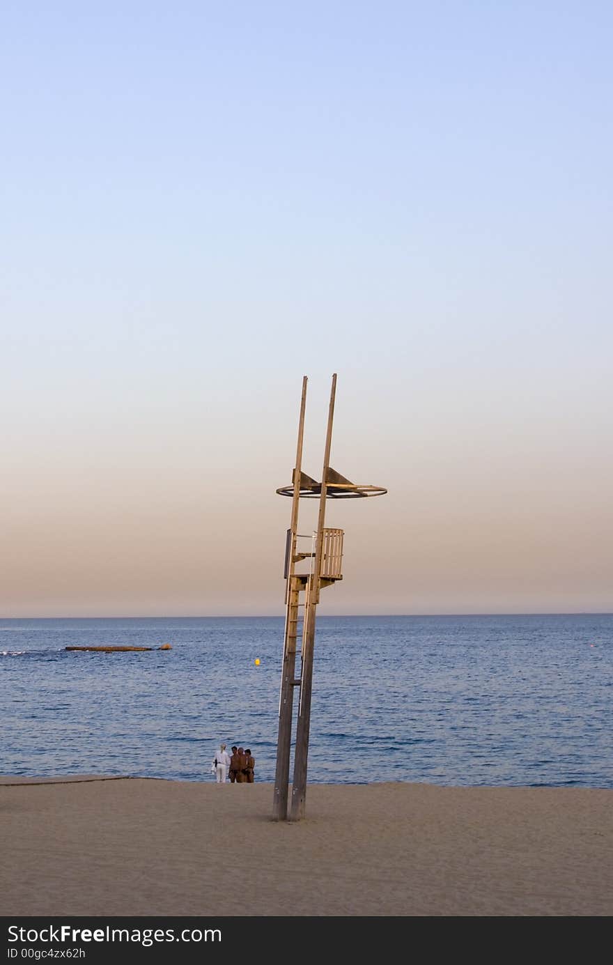 Beach and baywatch tower in a sunset