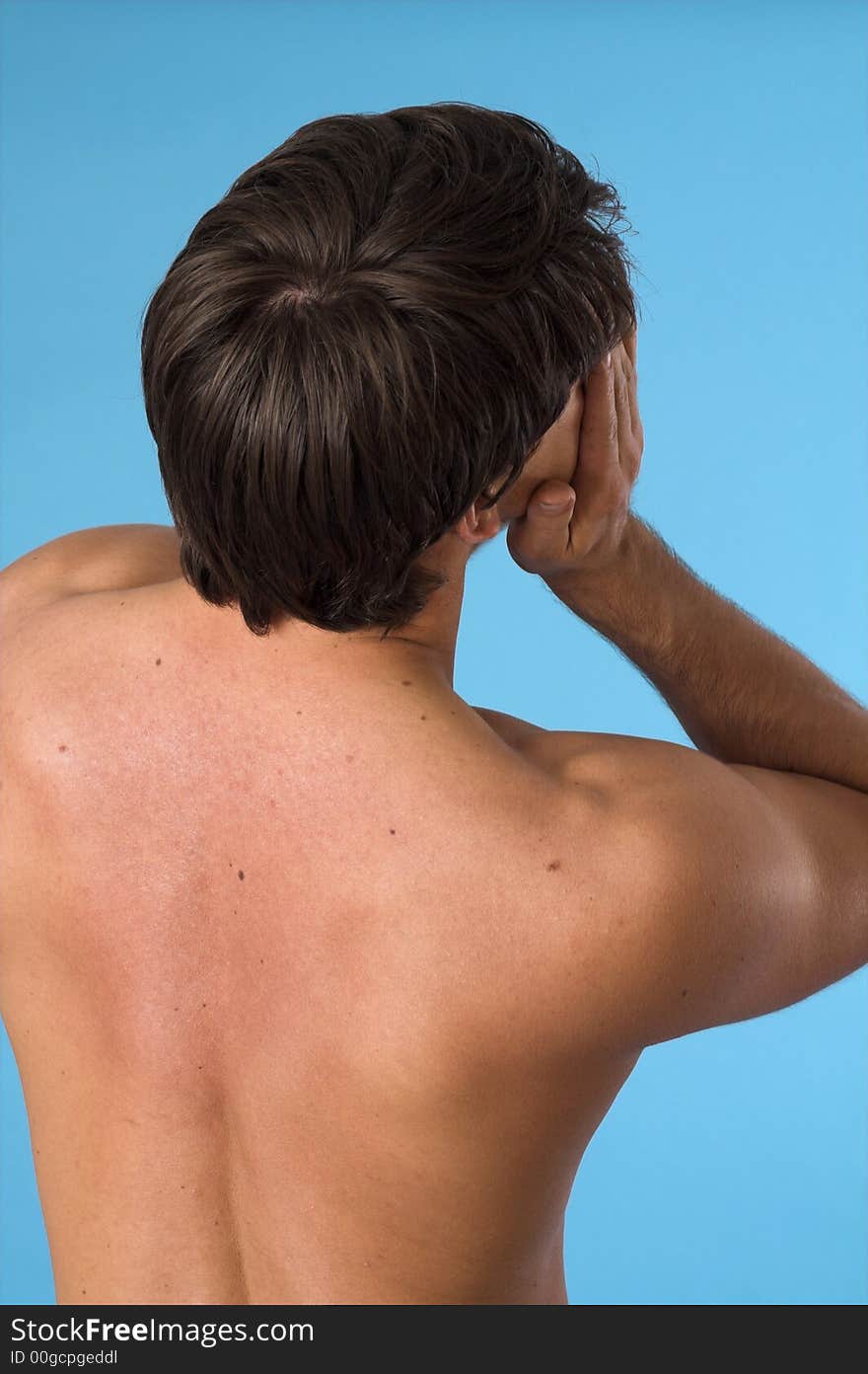 Close up of a young man back over blue background