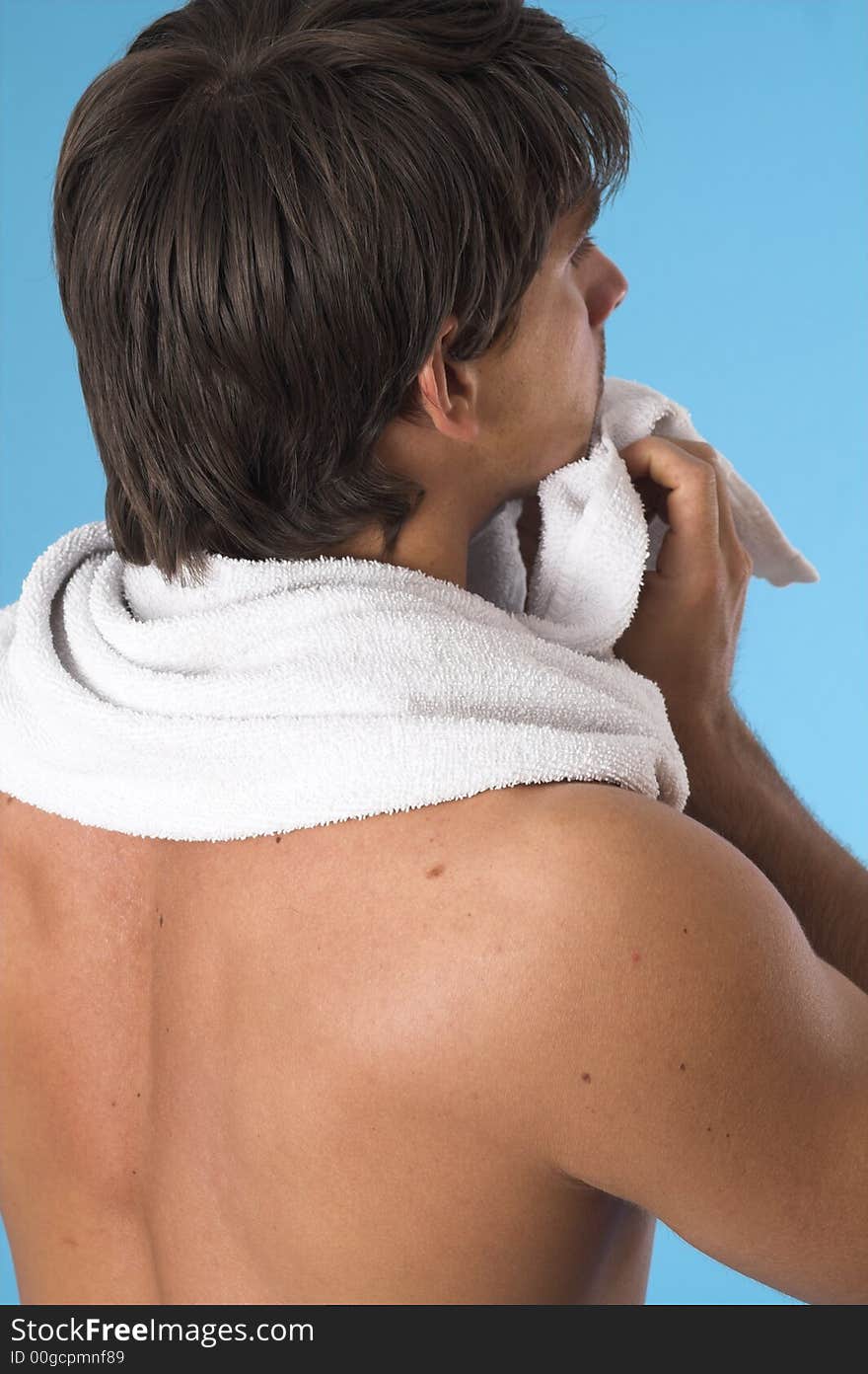 Close up of a young man back over blue background. Close up of a young man back over blue background