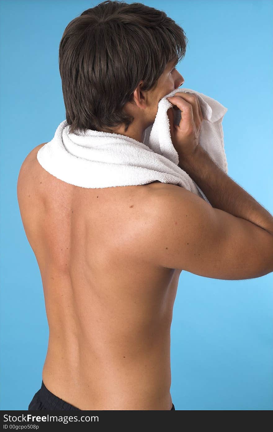 Close up of a young man back over blue background. Close up of a young man back over blue background