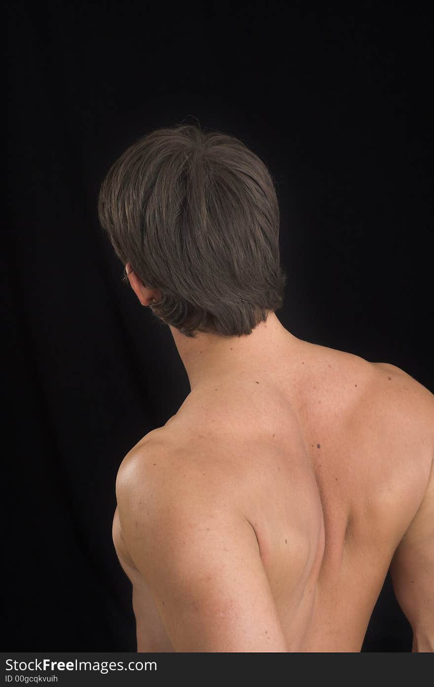 Close up of a young man back over black background