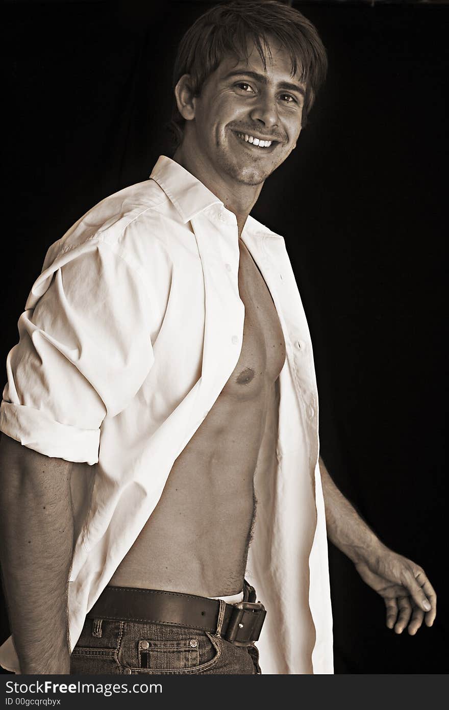 Portrait of young man smilling over black background. Portrait of young man smilling over black background