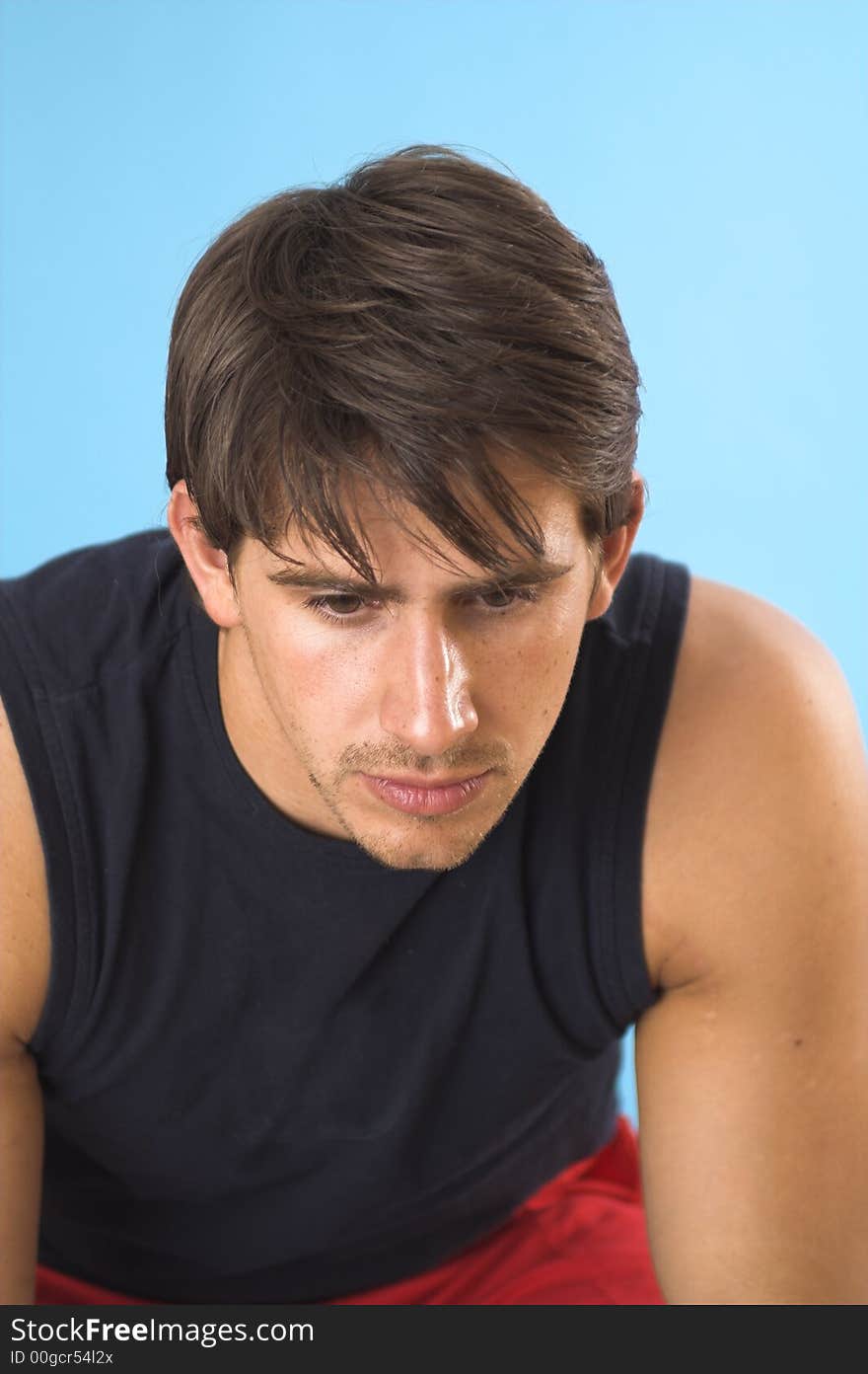 Portrait of a young man serious over blue background