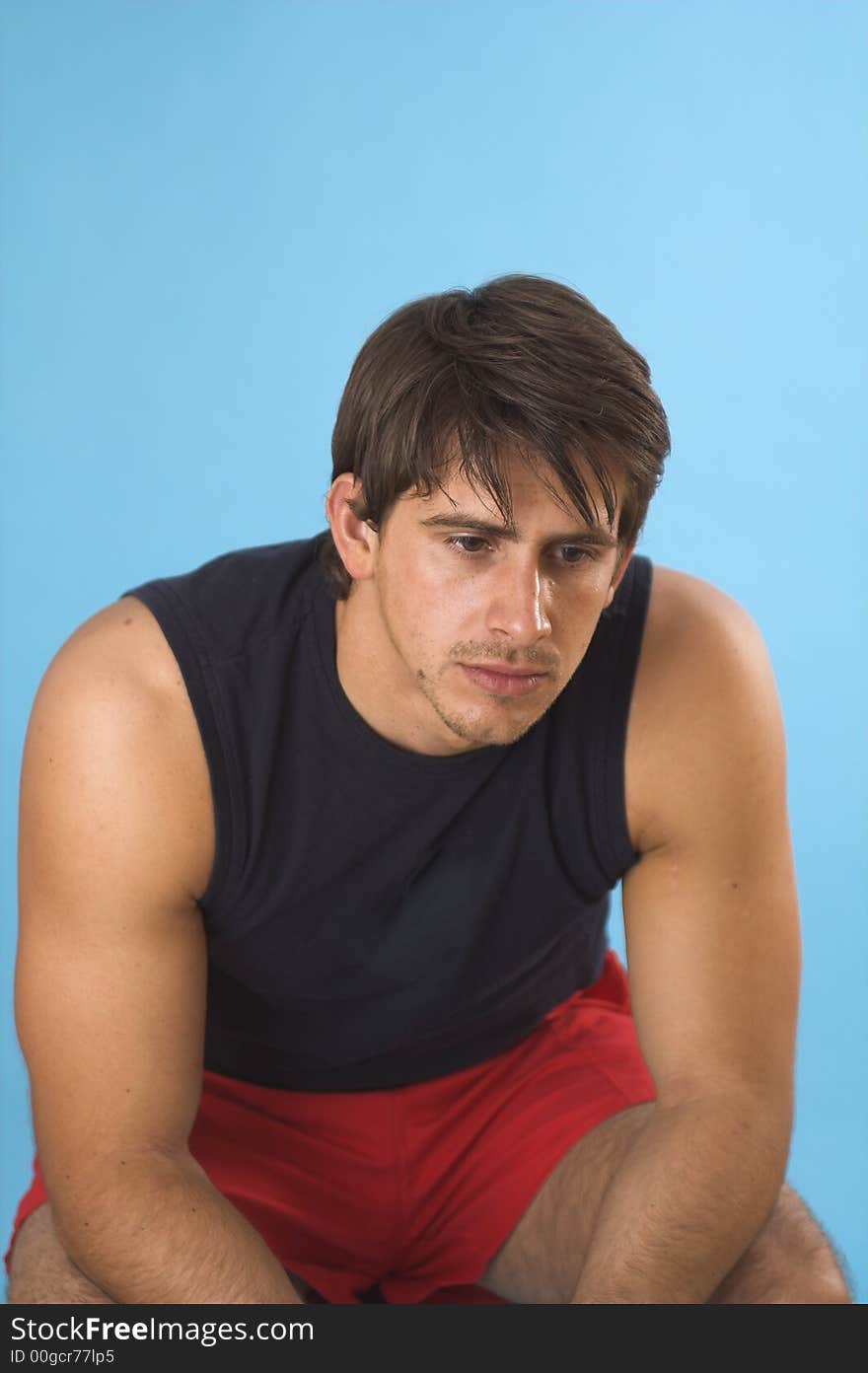 Portrait of a young man serious over blue background