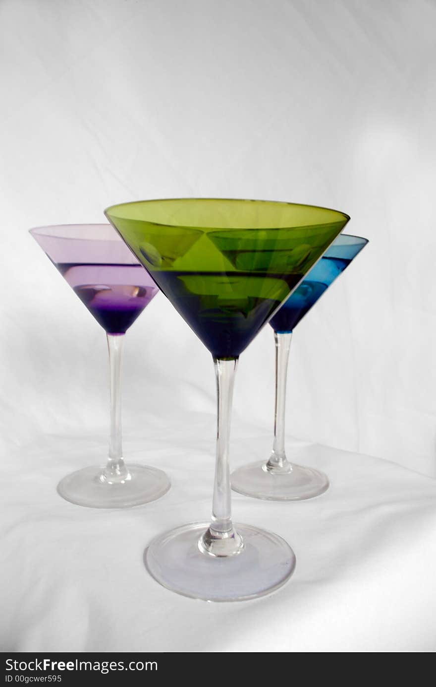 Brightly colored martini glasses on a white background. Brightly colored martini glasses on a white background