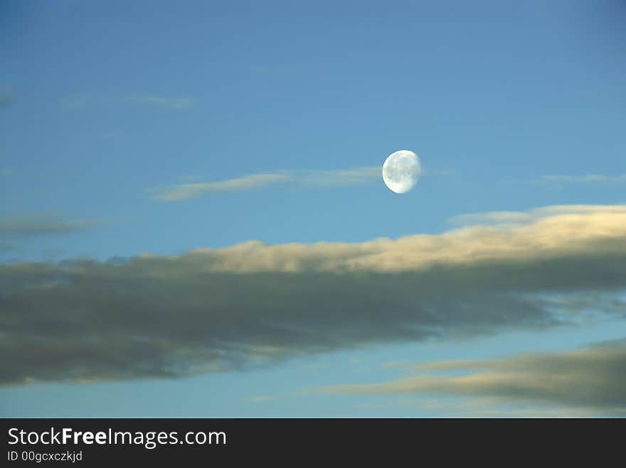 A beautiful moonrise in a cloudy twillight sky. A beautiful moonrise in a cloudy twillight sky