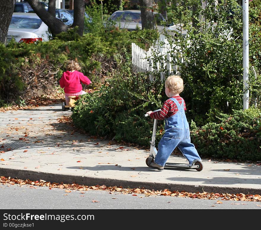 Two little children and their vehicles. Two little children and their vehicles