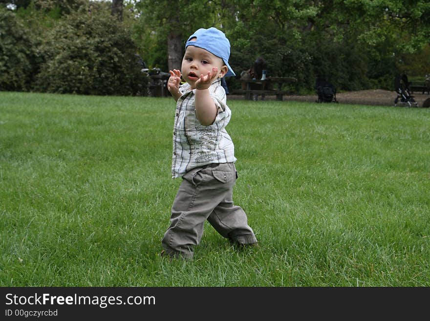 Baby, looking over his shoulder, while practicing walking. Baby, looking over his shoulder, while practicing walking