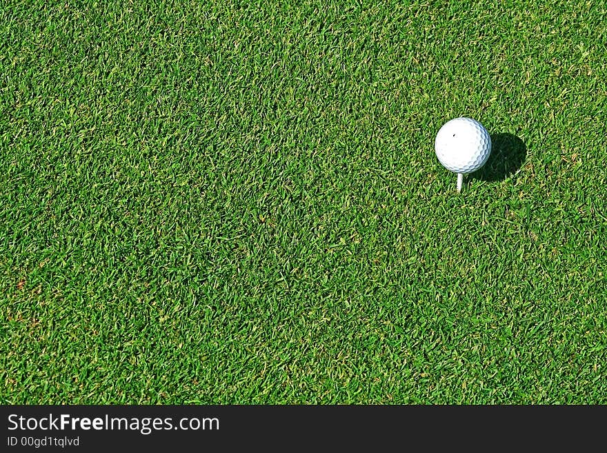 White Golf Ball on Tee ready to be hit. Good sports background. White Golf Ball on Tee ready to be hit. Good sports background.