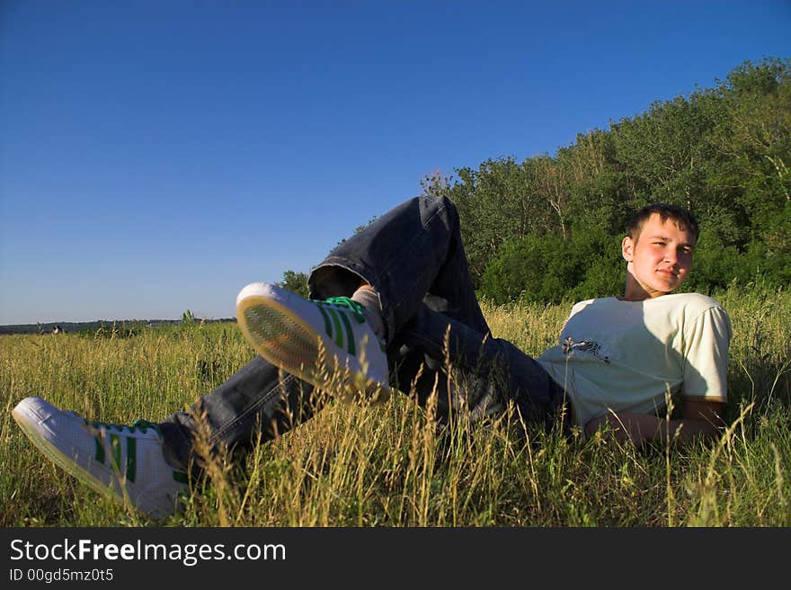 Young man on deep blue sky