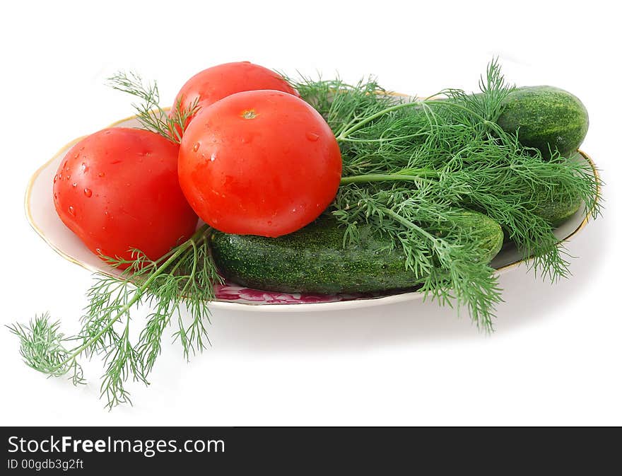 Tomatoes and cucumbers on plate isolated