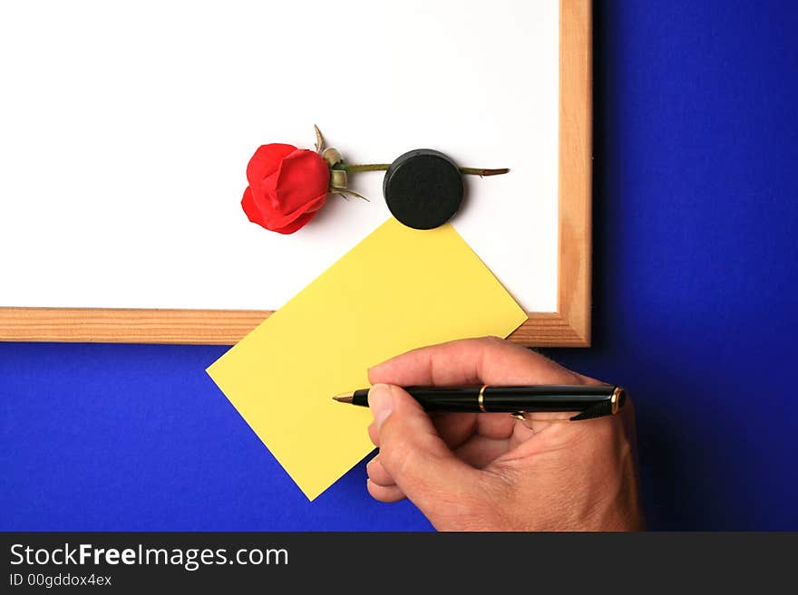 Whiteboard with empty yellow post-it note and magnet and hand ready to write.white-board with empty yellow post-it note and magnet ready for a message.please take a look at my other images of this item. Whiteboard with empty yellow post-it note and magnet and hand ready to write.white-board with empty yellow post-it note and magnet ready for a message.please take a look at my other images of this item