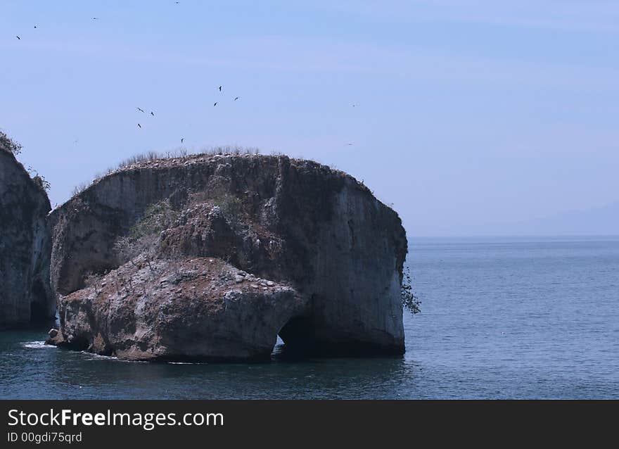 Giant rocks with arches off the coast. Giant rocks with arches off the coast