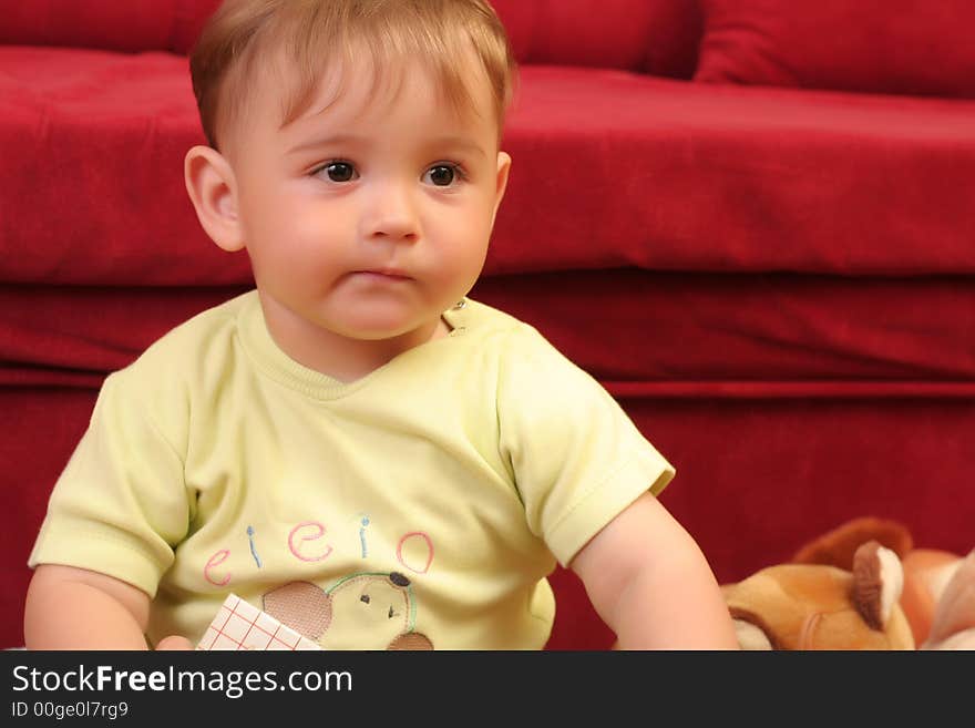 Expressive little blond baby boy gesticulate while reading a child book