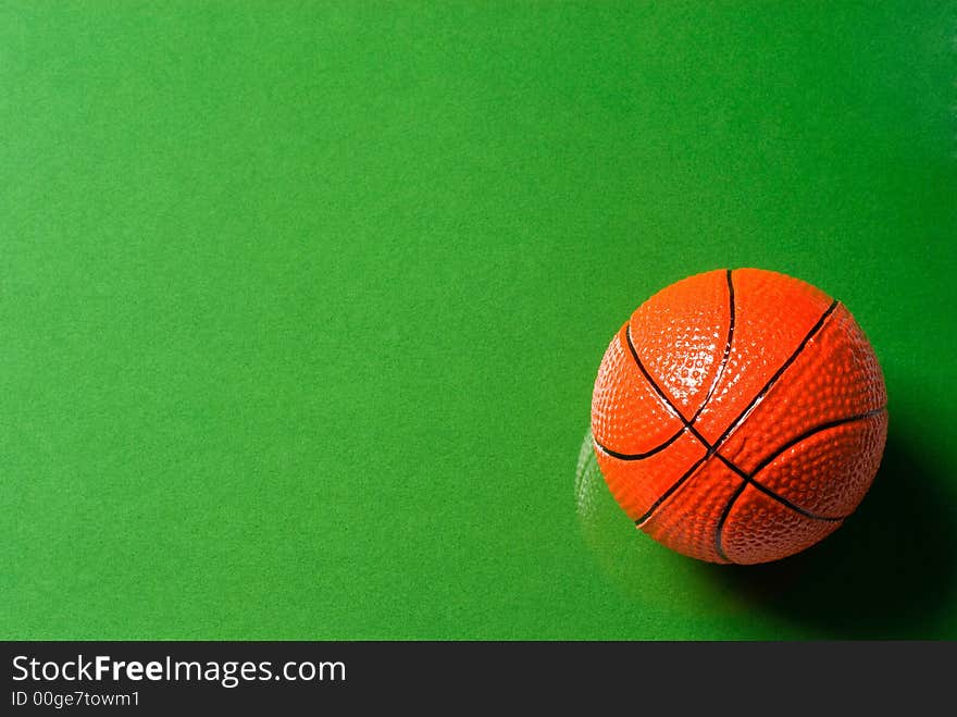 Basketball ball on glass with a green background