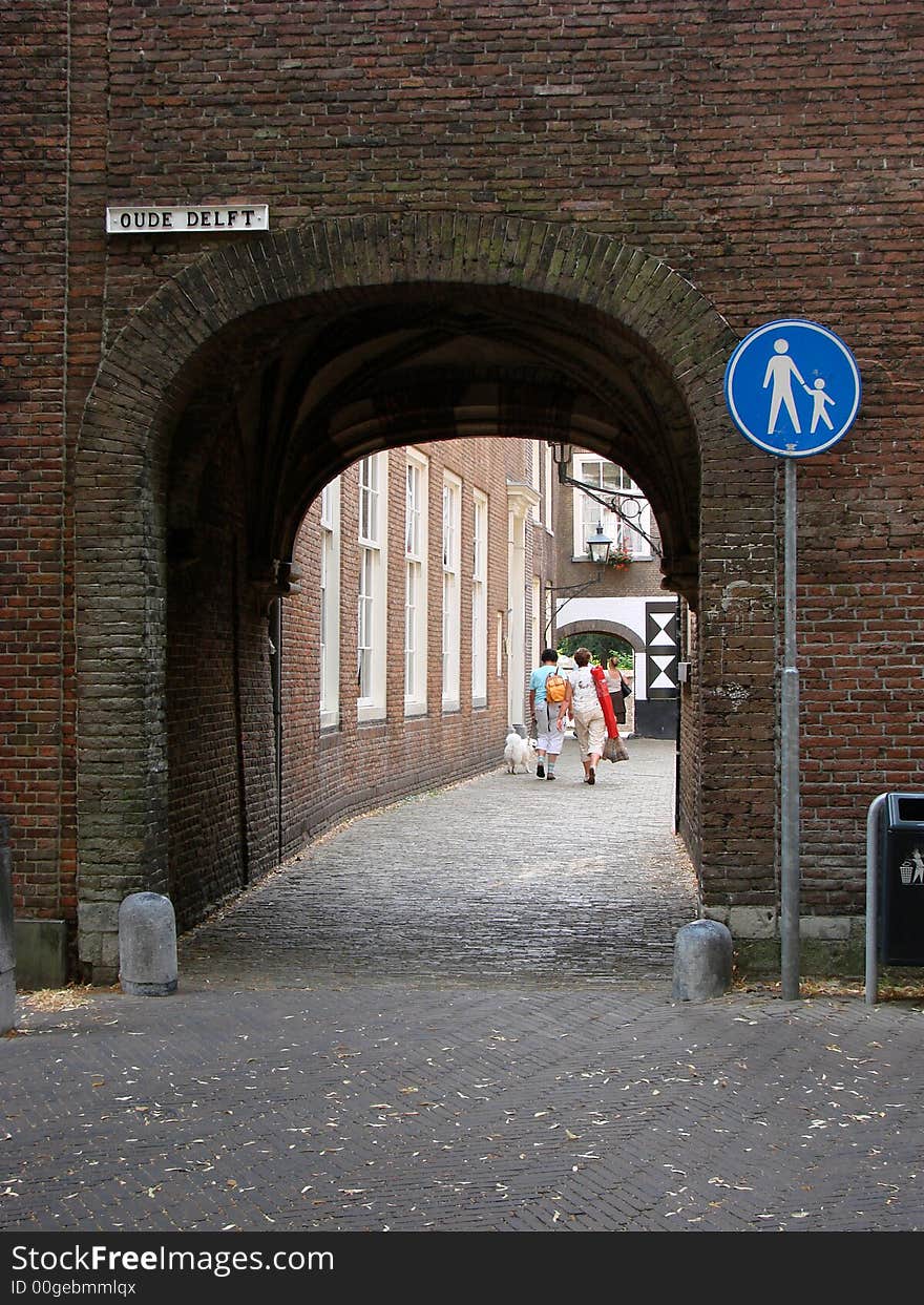 An old-fashioned passageway with an interesting signpost in the city of Delft, Netherlands. An old-fashioned passageway with an interesting signpost in the city of Delft, Netherlands.