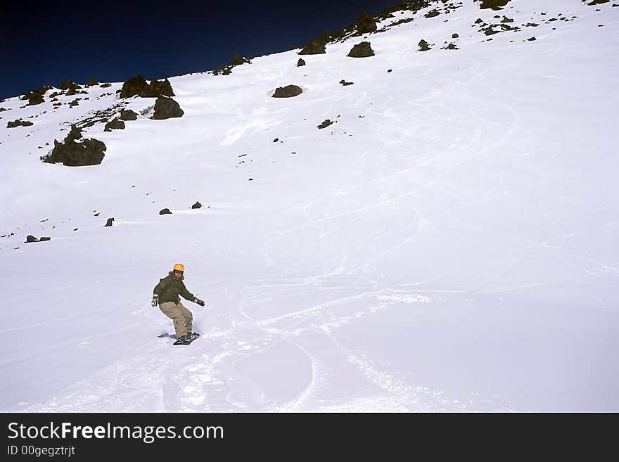 Girl riding snowboard on mountain's slope. Girl riding snowboard on mountain's slope