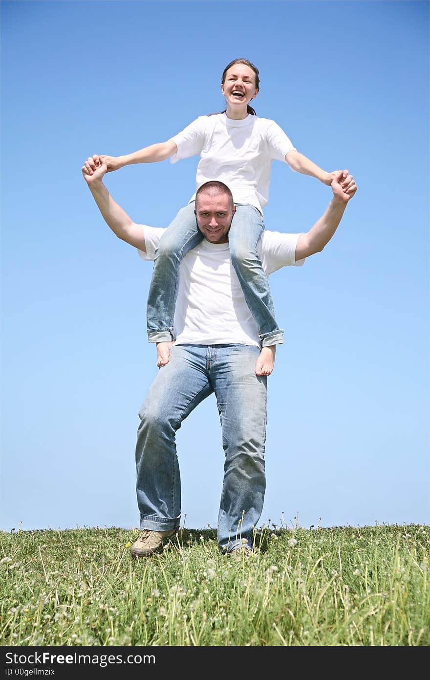 The friend holds the girlfriend in a white T-short. The friend holds the girlfriend in a white T-short