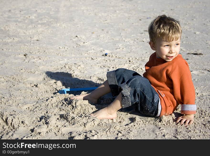 Boy sitting on the sand