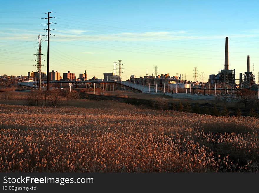 Empty field during susnet with city in background. Empty field during susnet with city in background