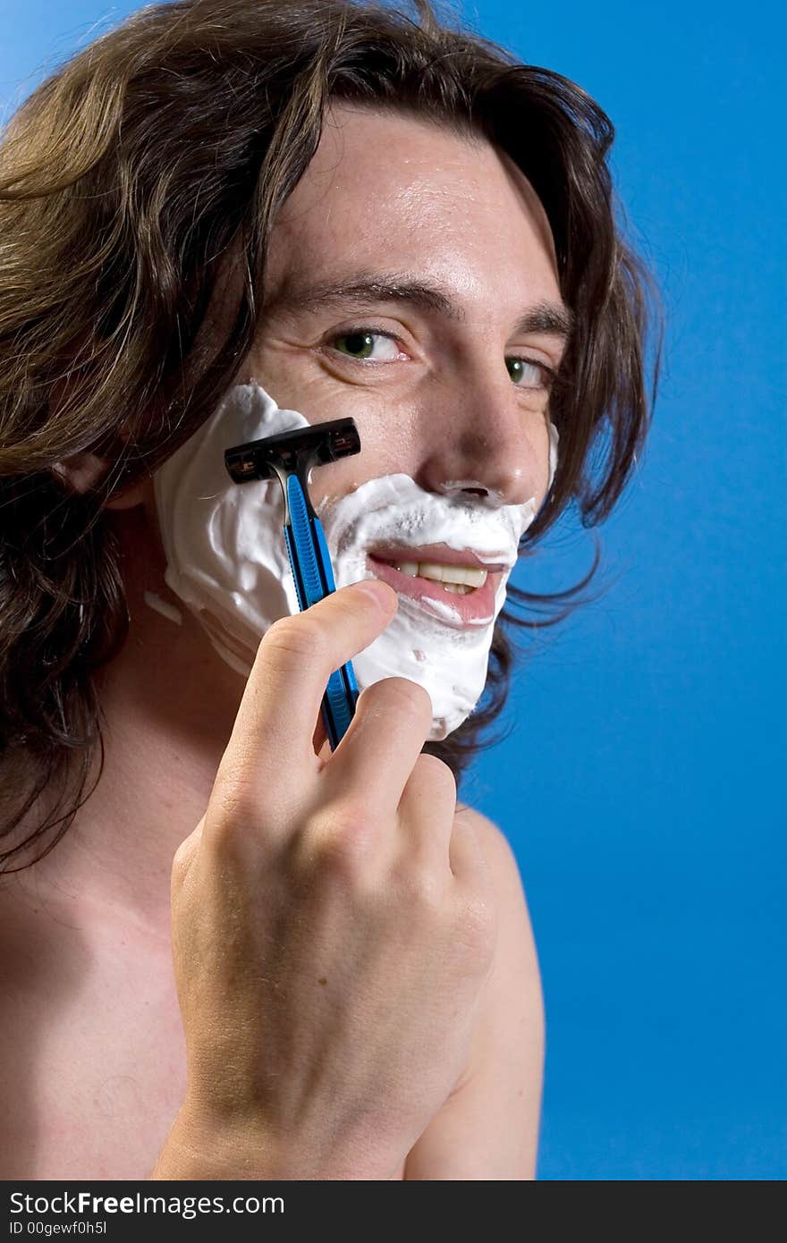 Young man portrait shaving himself. Young man portrait shaving himself