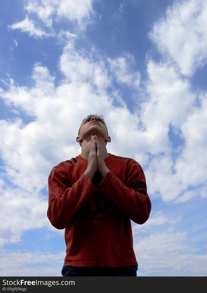 The boy stands on a sky background. The boy stands on a sky background