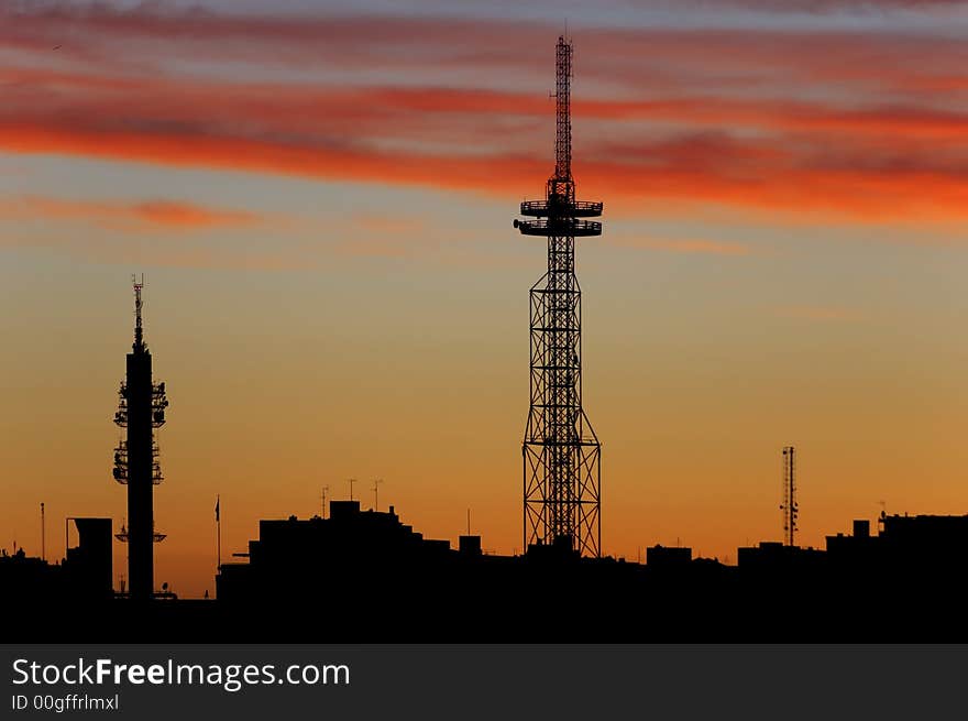 City silhouette against a sunset sky