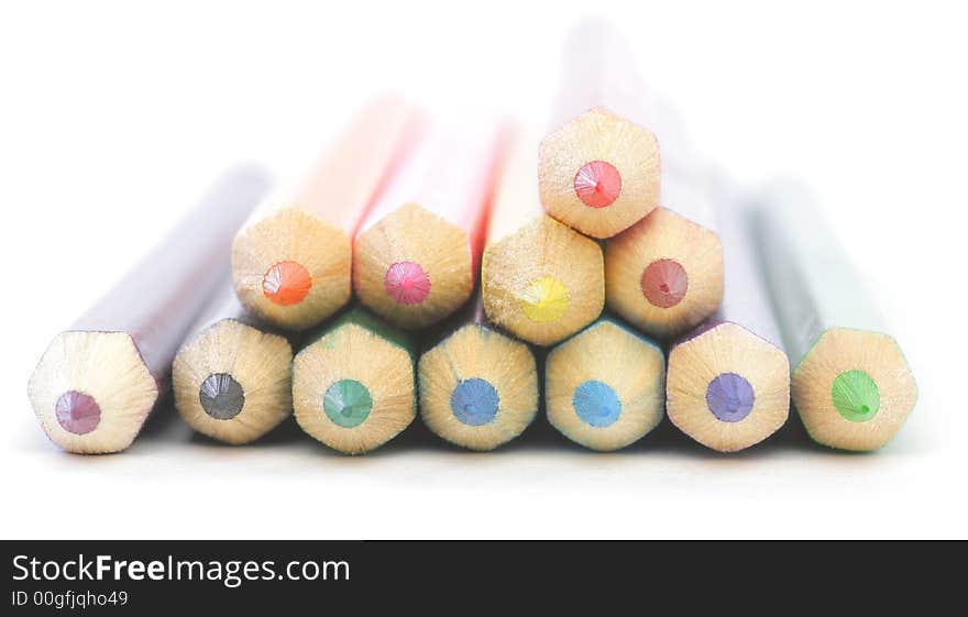 Colored wooden Crayons. Isolated on white background. Soft focus.