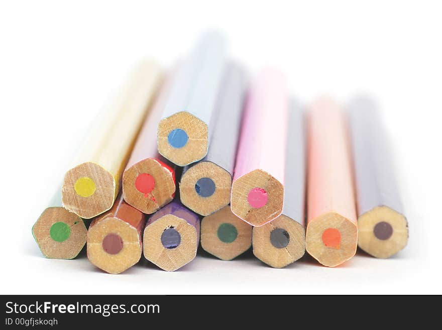 Colored wooden Crayons. Isolated on white background. Soft focus.