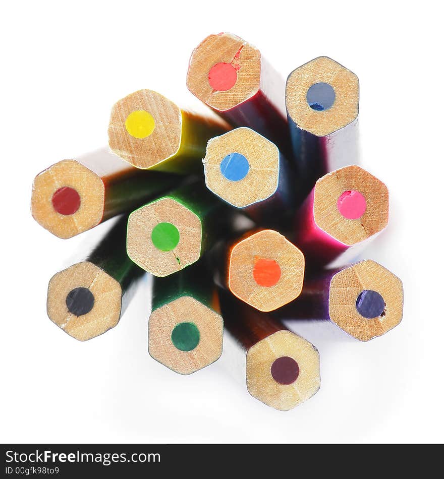 Colored wooden Crayons. Isolated on white background. Downside view. Soft focus.