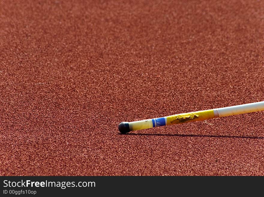 Pole jumping pole lying on a track