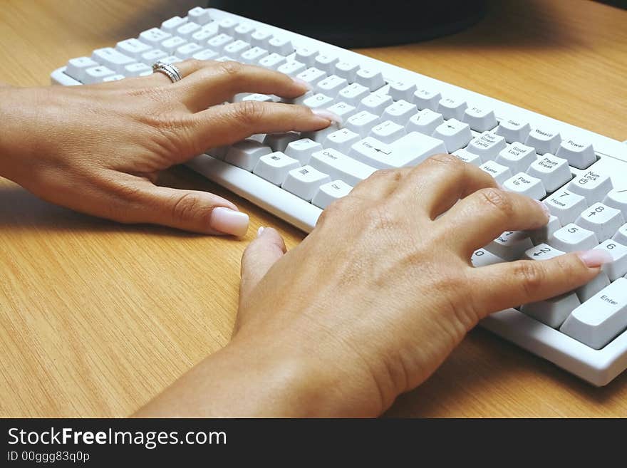 Closeup of woman typing on a keyboard