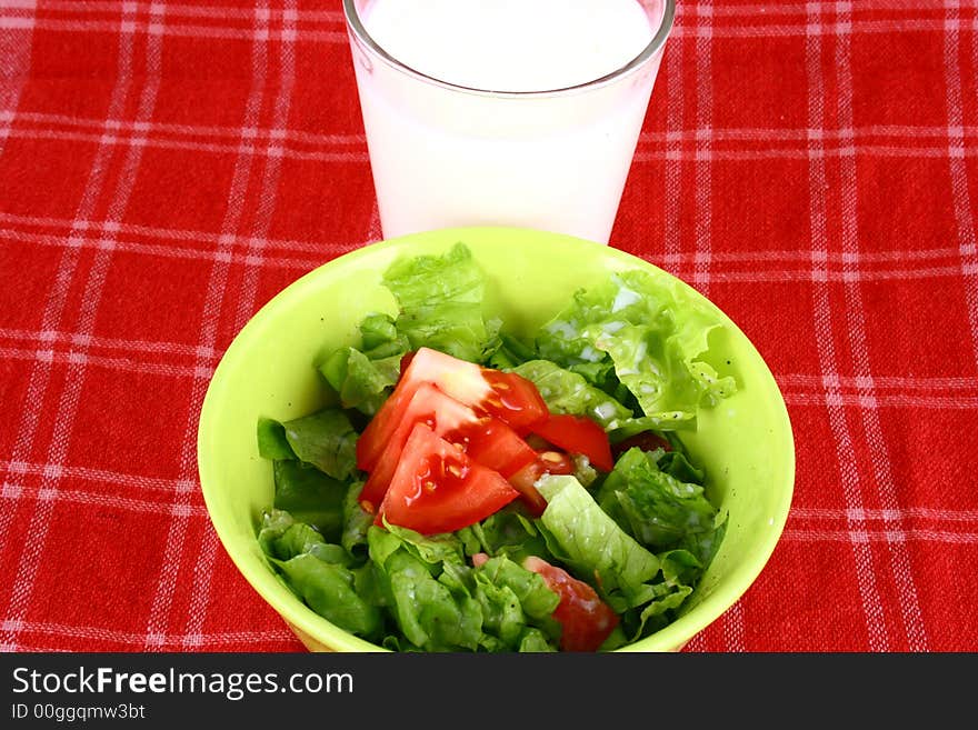 Fresh baby greens salad and tomatoes close up. Fresh baby greens salad and tomatoes close up