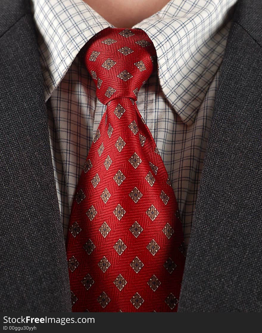 Close-up of red tie and black suit. Close-up of red tie and black suit