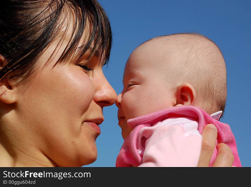 Mother and newborn girl on sky background. Mother and newborn girl on sky background