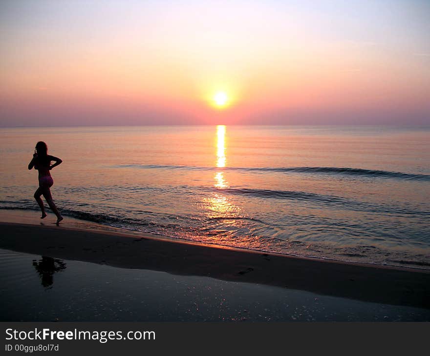 Woman is running at polish sea in Miedzyzdroje. Woman is running at polish sea in Miedzyzdroje