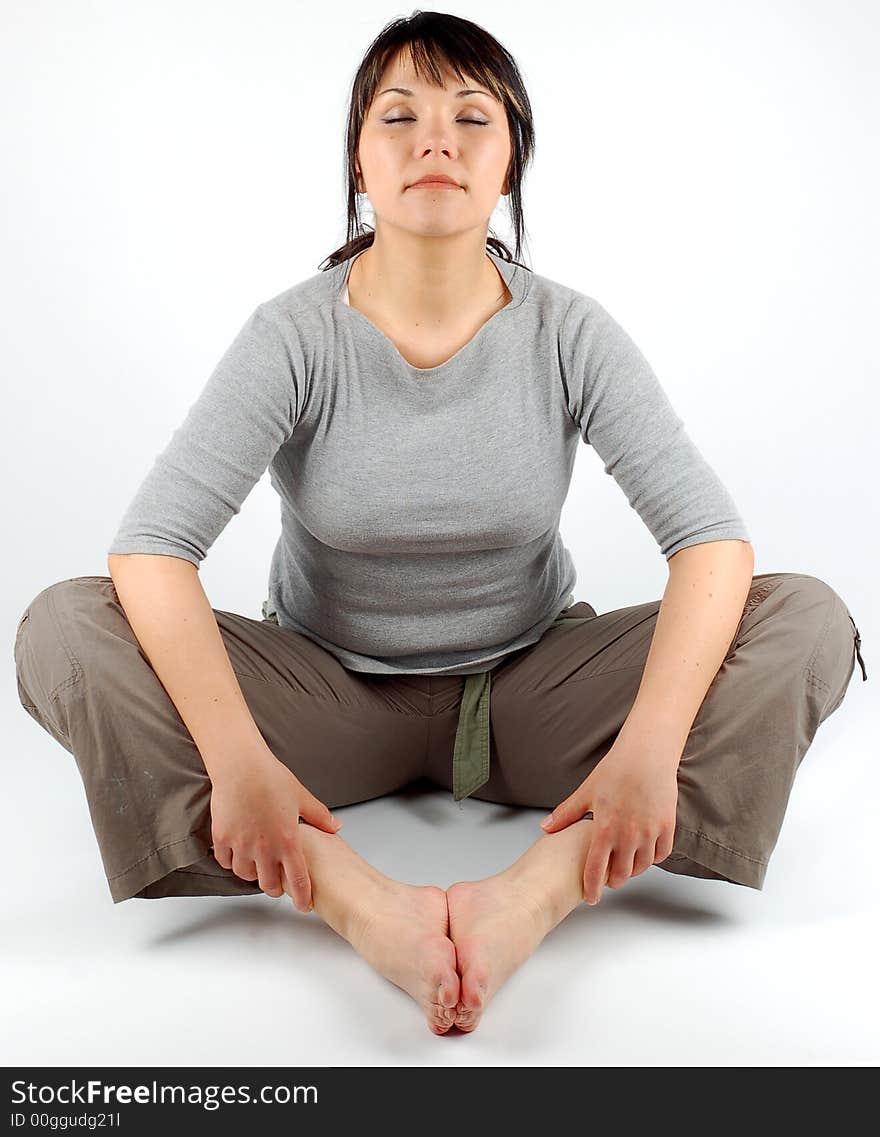 Attractive woman sitting on floor on white background. Attractive woman sitting on floor on white background