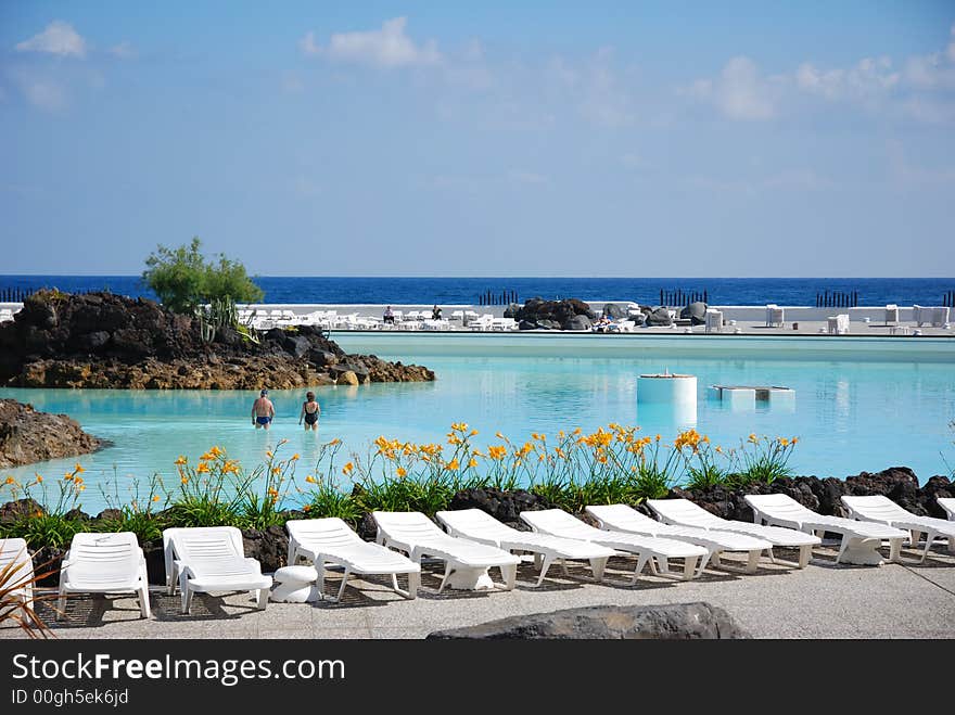 Couches at swimming pool of a tourist resort