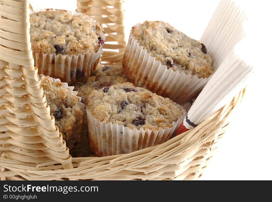 Close-up of fresh baked muffins in a basket. Close-up of fresh baked muffins in a basket.