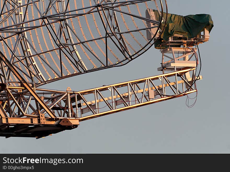 An radar dish turns to gold at sunset. An radar dish turns to gold at sunset