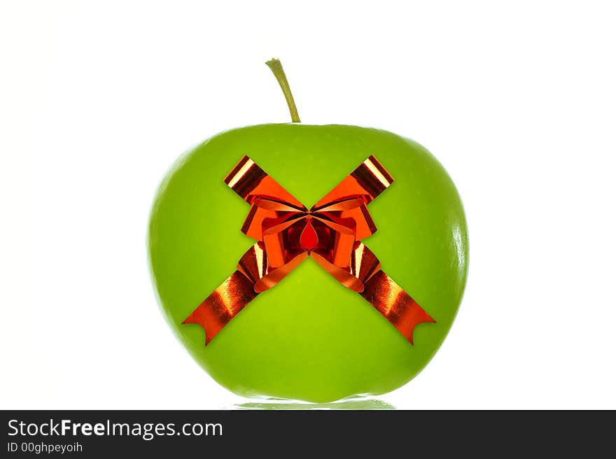 Green apple with a red ribbon. Isolated over white background