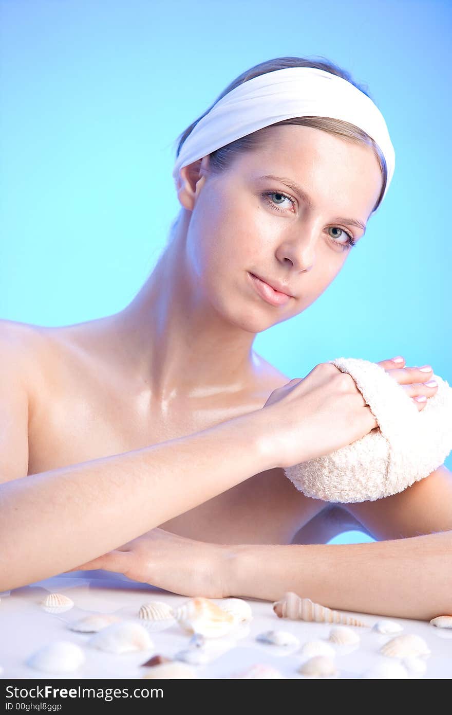 Young beautiful smiling woman with a bath sponge. Young beautiful smiling woman with a bath sponge